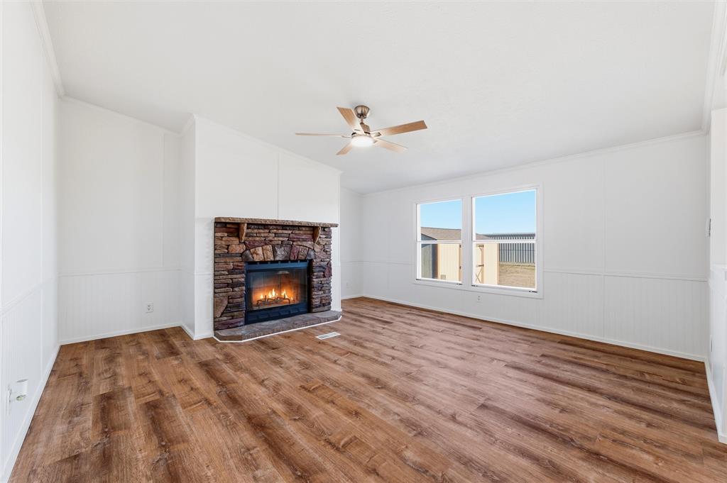 237 Quarterhorse Road Waxahachie, TX 75165 - Photo 9 of 38 a view of an empty room with a window and a fireplace