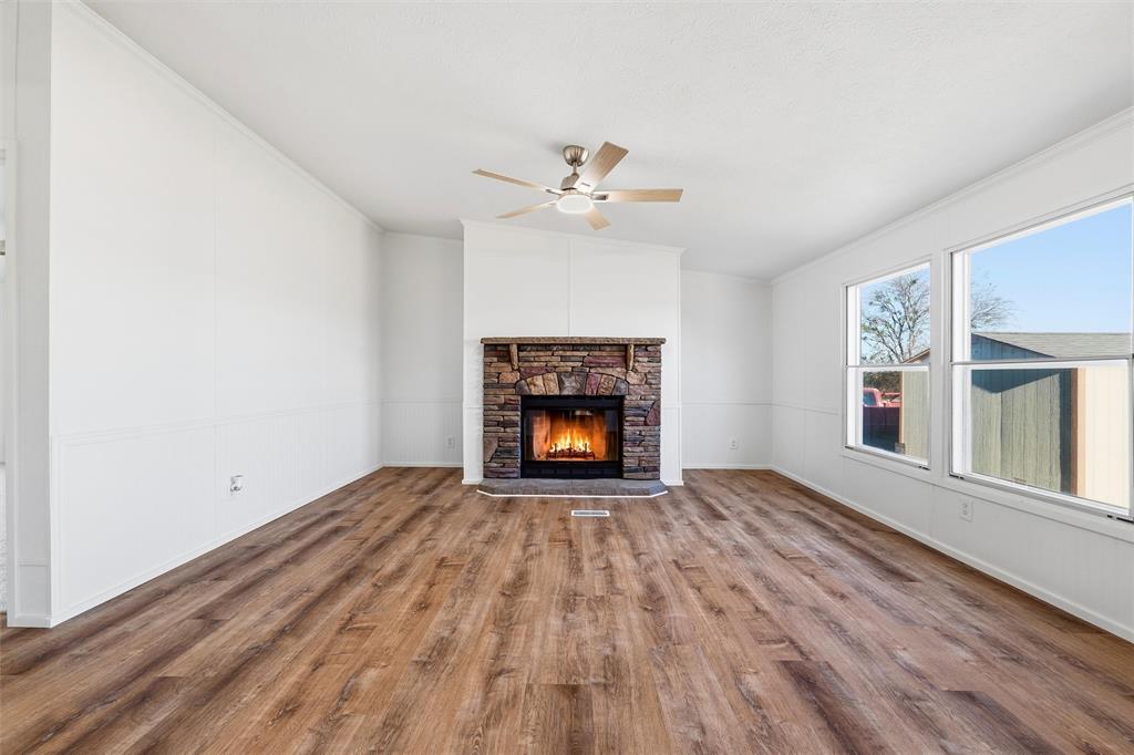 237 Quarterhorse Road Waxahachie, TX 75165 - Photo 10 of 38 wooden floor fireplace and window in an empty room
