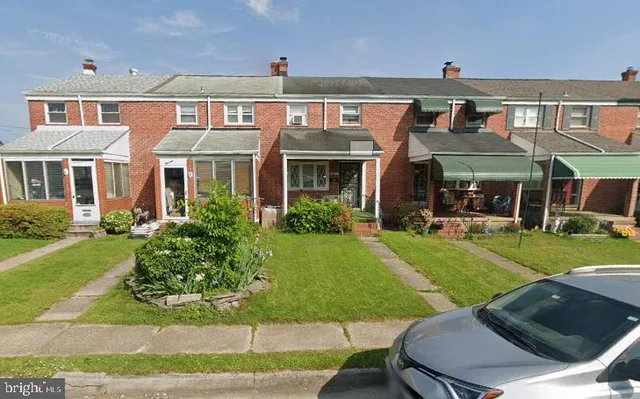 a front view of a house with a yard table and chairs