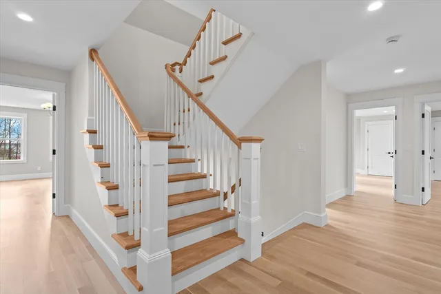 a view of entryway with wooden floor and stairs