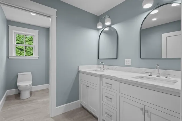 a bathroom with a double vanity sink and a mirror
