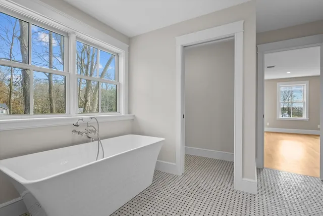 a white bath tub sitting next to a window
