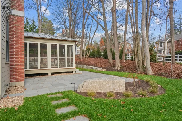 front view of a house with a yard and an trees