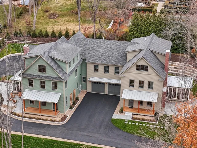 a white house covered with tall trees