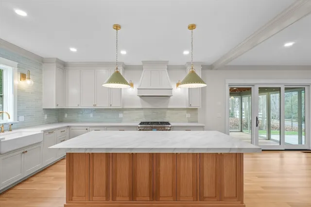 a kitchen that has a lot of cabinets and wooden floor