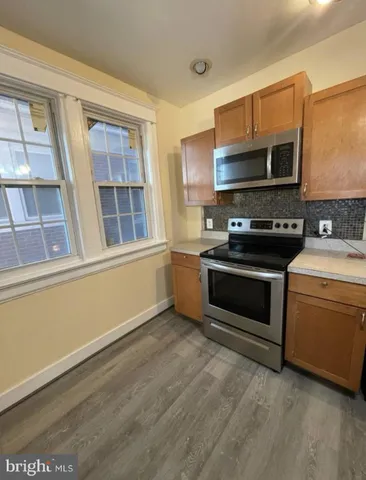 a kitchen with stainless steel appliances a stove and a sink