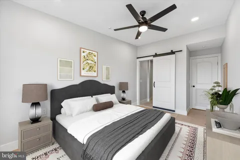 a bedroom with a large bed and a chandelier