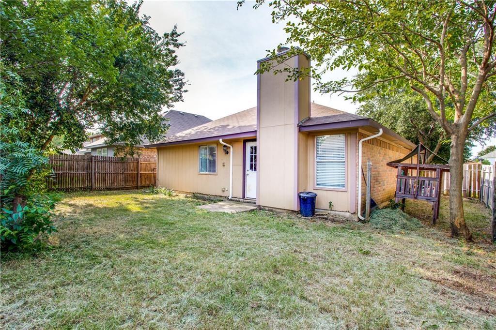 6817 Haltom Road Fort Worth, TX 76137 - Photo 2 of 25 Expansive rear yard featuring mature trees and a wooden privacy fence