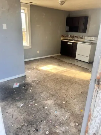 a view of kitchen with stove top oven and cabinets