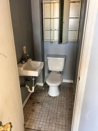 a bathroom with a toilet and a sink