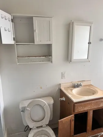 a bathroom with a sink a toilet and mirror