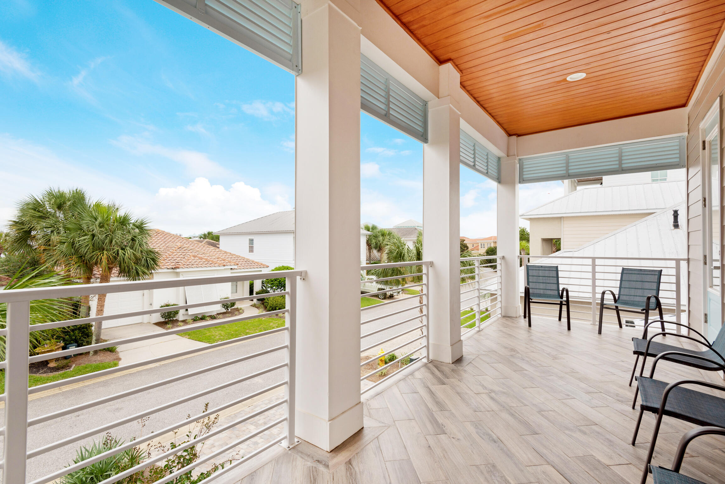 55 St Simon Circle Miramar Beach, FL 32550 - Photo 26 of 45 a balcony with chairs and with wooden floor