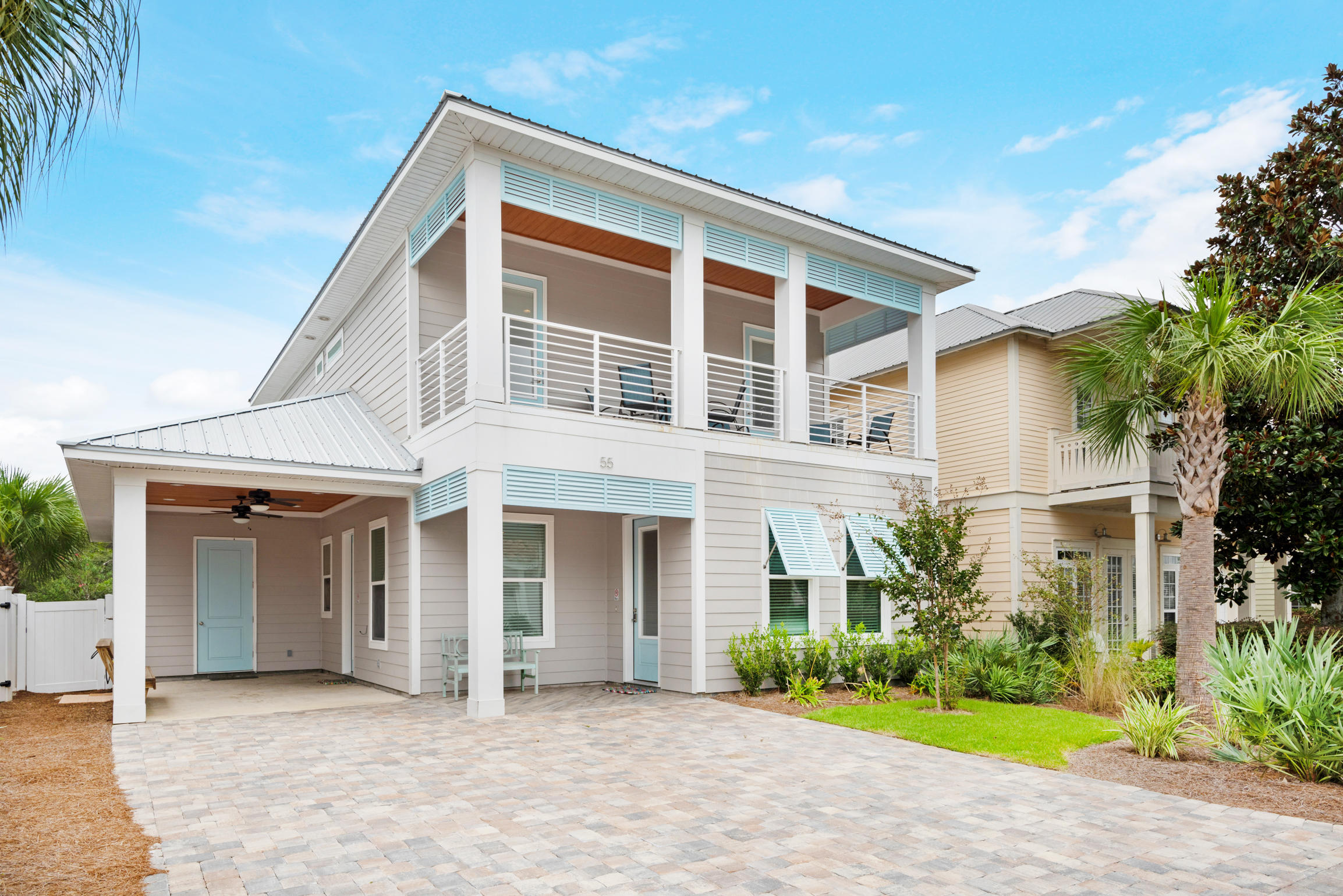 55 St Simon Circle Miramar Beach, FL 32550 - Photo 5 of 45 a front view of a house with a yard and potted plants