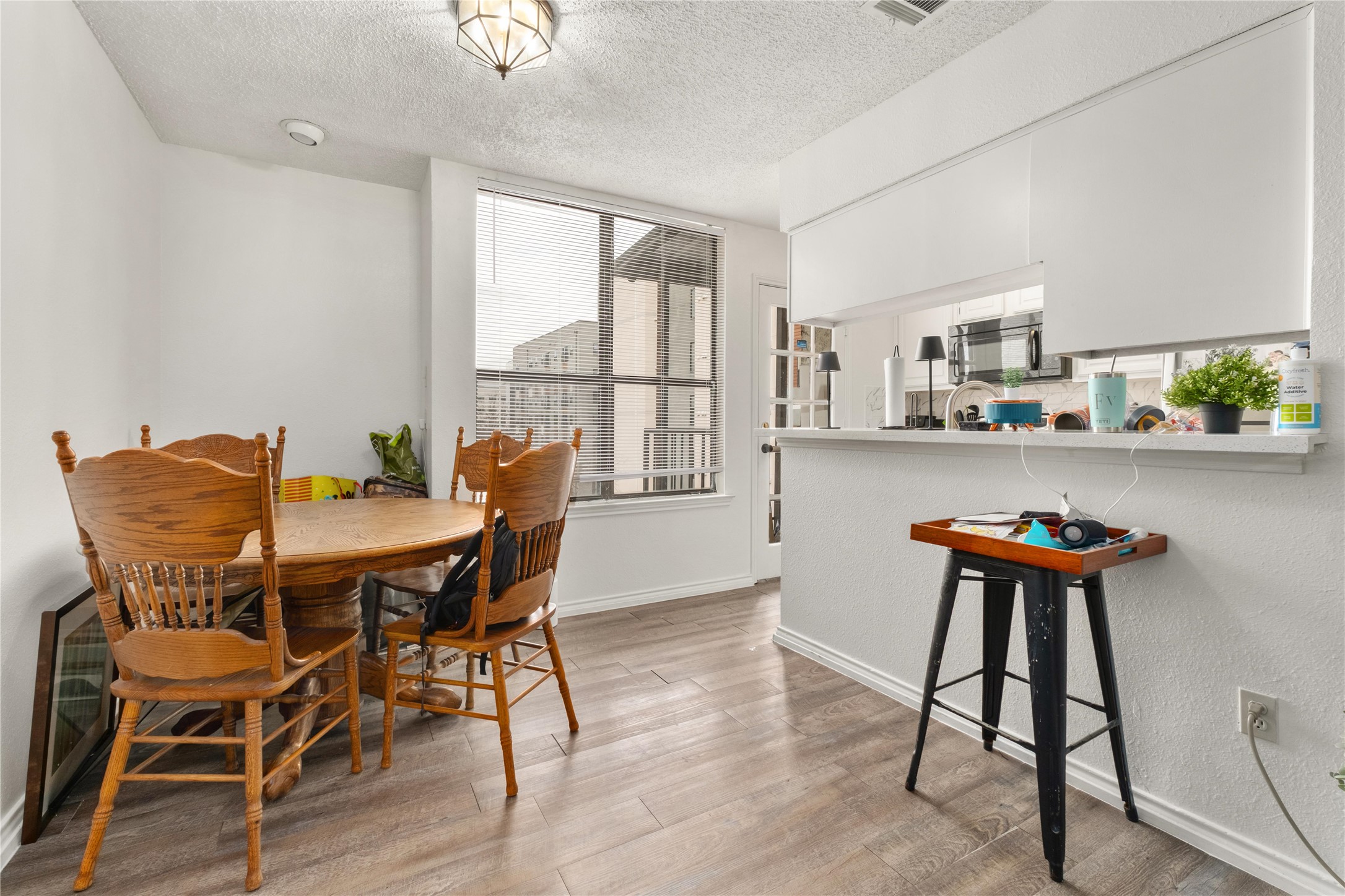2409 Leon Street, Unit 307 Austin, TX 78705 - Photo 6 of 23 a view of a dining room with furniture and wooden floor