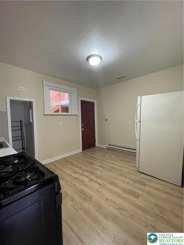 a kitchen with a stove and a refrigerator