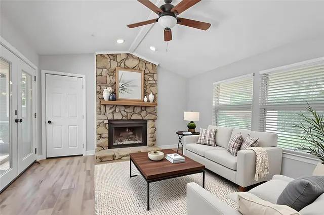 a living room with furniture and a fireplace