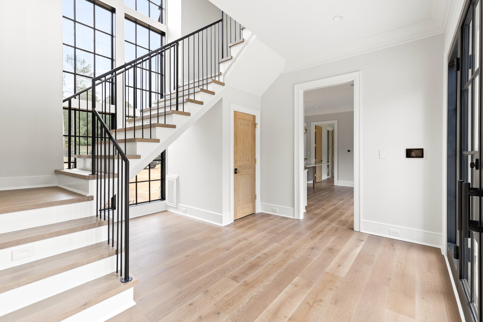 155 Settlement Drive Apex, NC 27523 - Photo 22 of 65 a view of entryway and hall with wooden floor