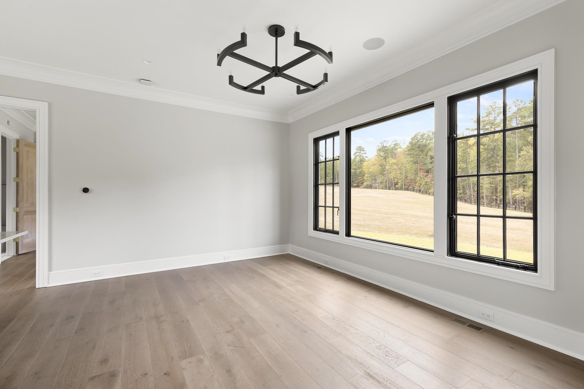 155 Settlement Drive Apex, NC 27523 - Photo 35 of 65 a view of empty room with wooden floor and fan