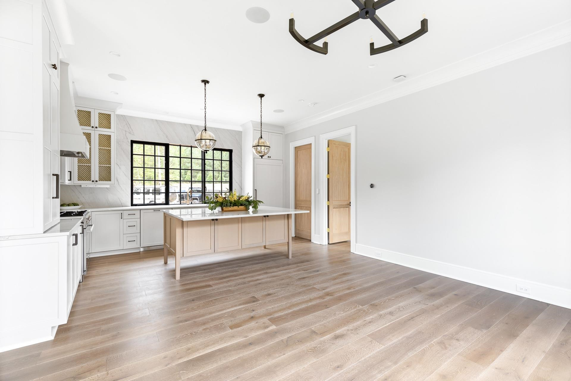 155 Settlement Drive Apex, NC 27523 - Photo 37 of 65 a large kitchen with a wooden floor and outdoor space