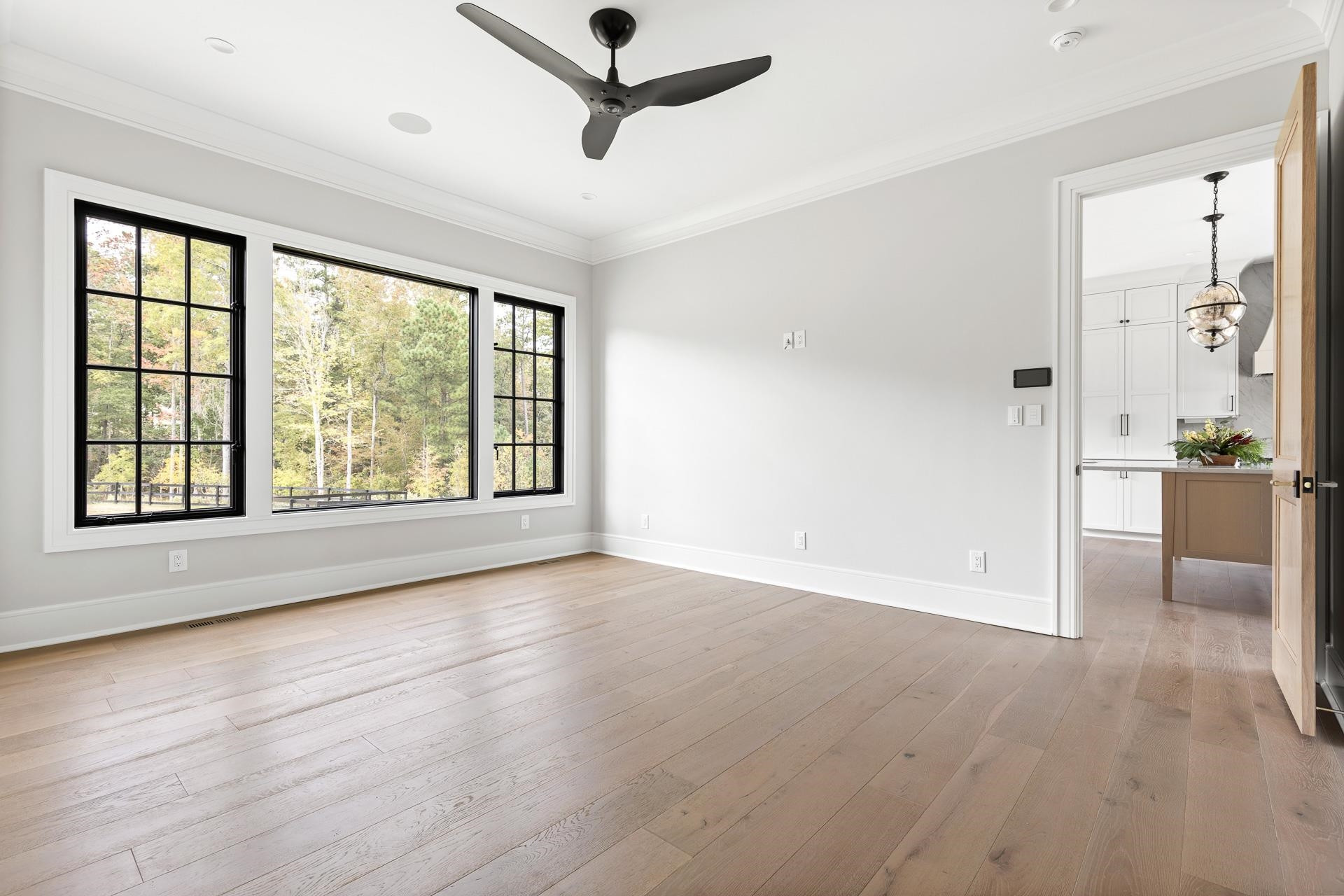 155 Settlement Drive Apex, NC 27523 - Photo 38 of 65 a view of an empty room with a window and wooden floor