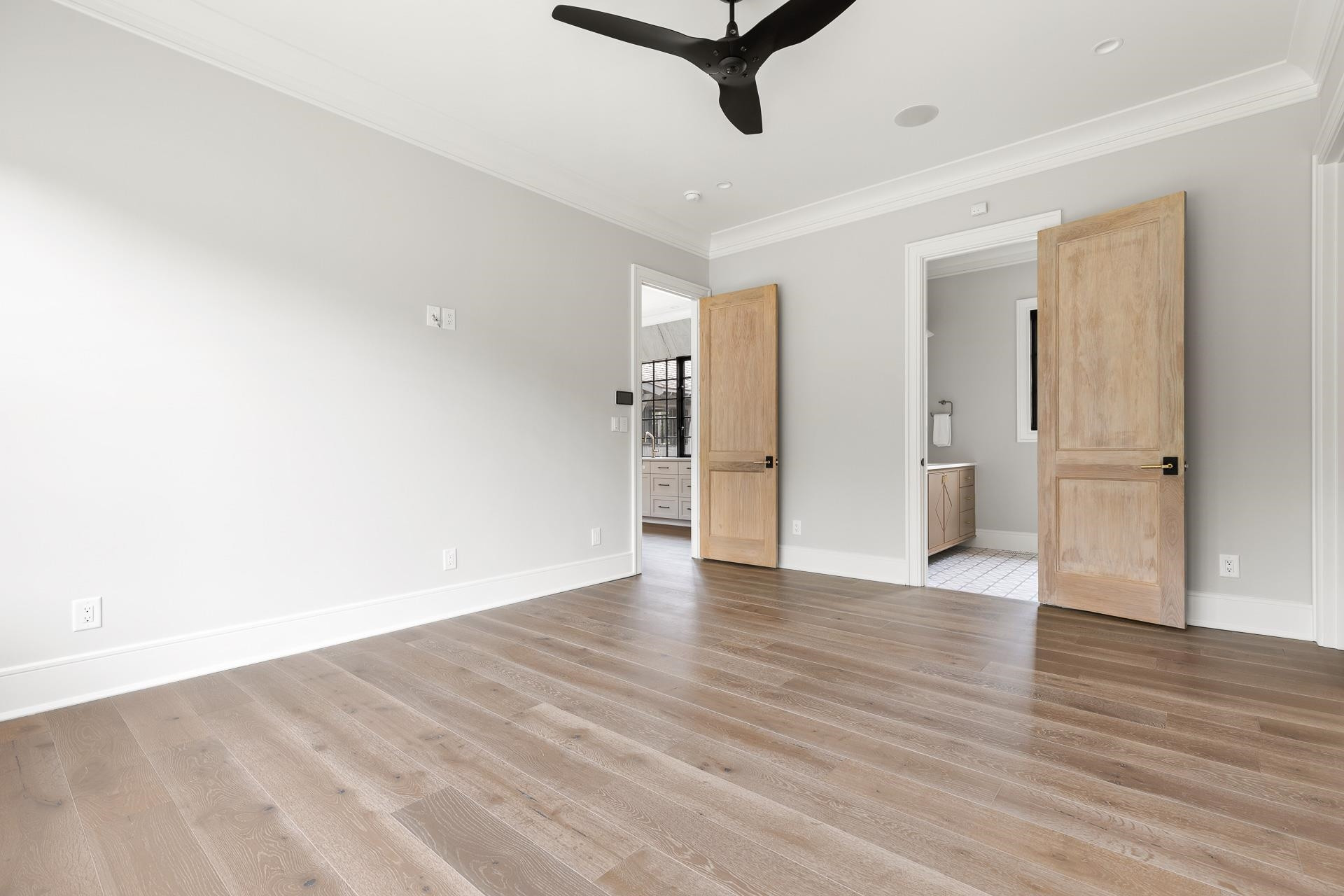 155 Settlement Drive Apex, NC 27523 - Photo 40 of 65 a view of a room with wooden floor and a ceiling fan