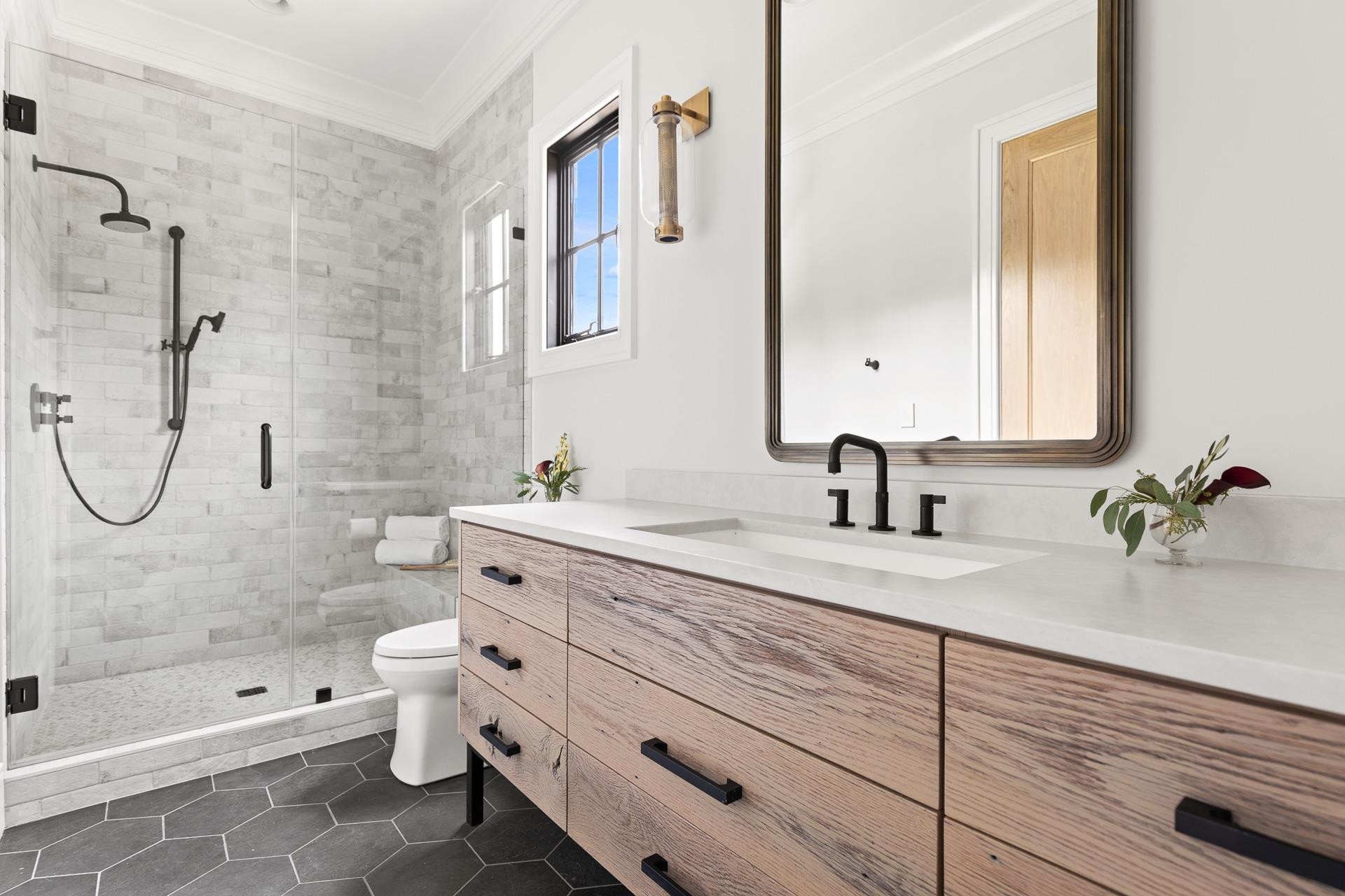 155 Settlement Drive Apex, NC 27523 - Photo 45 of 65 a bathroom with a granite countertop sink a toilet and shower