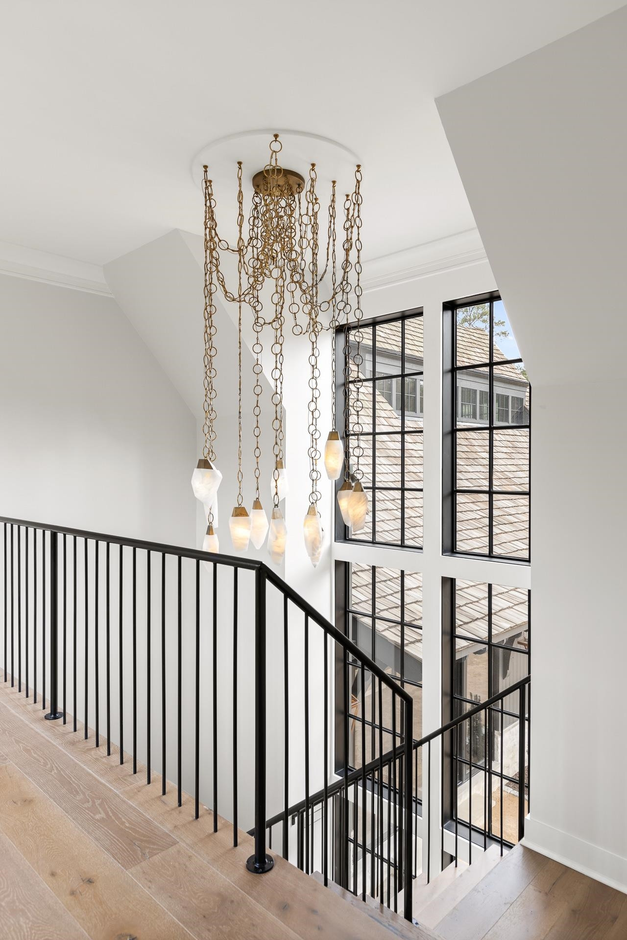 155 Settlement Drive Apex, NC 27523 - Photo 49 of 65 a view of staircase with railing and a chandelier