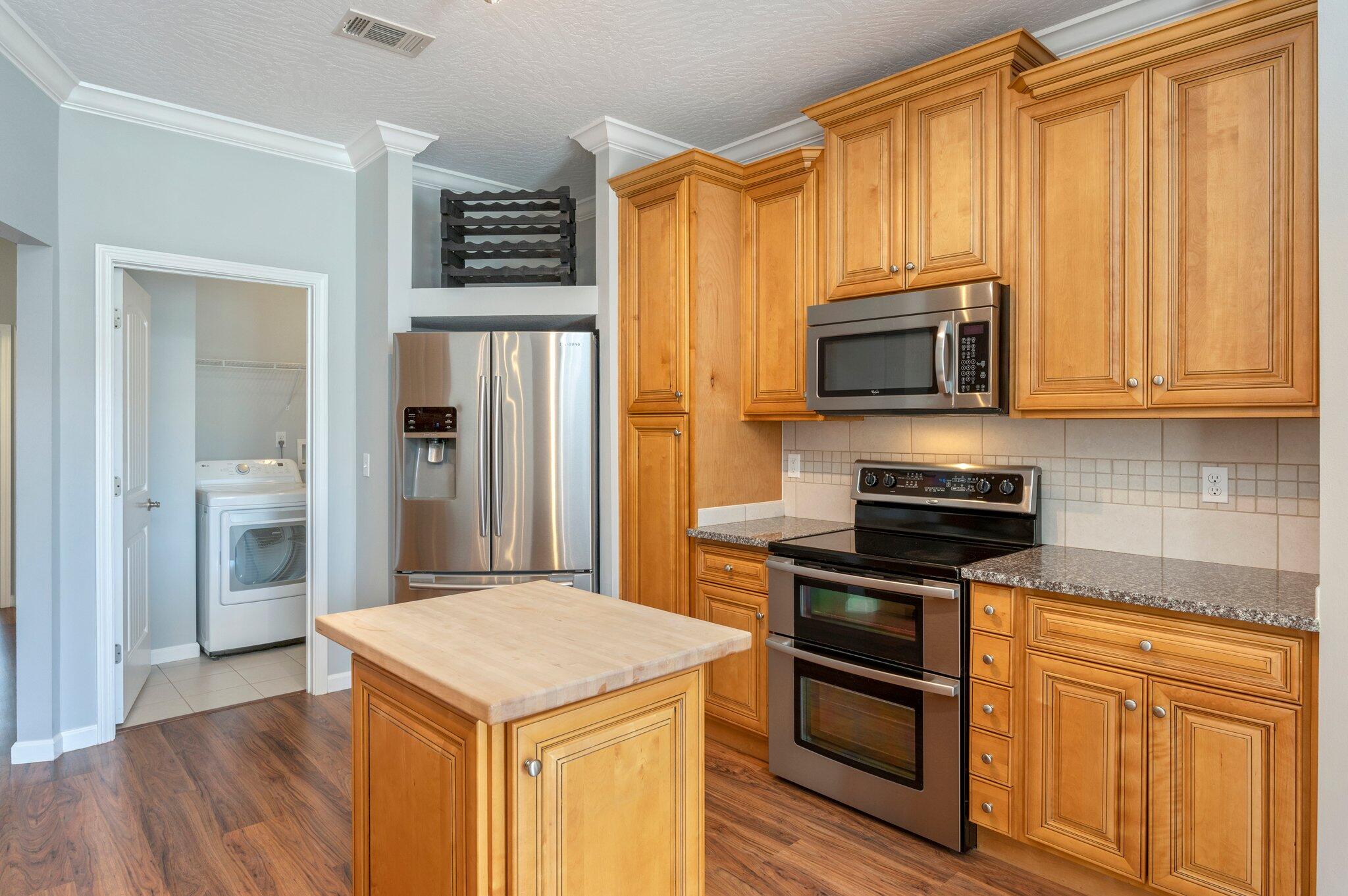 4623 Hermosa Road Crestview, FL 32539 - Photo 12 of 41 a kitchen with stainless steel appliances a stove a microwave and a sink
