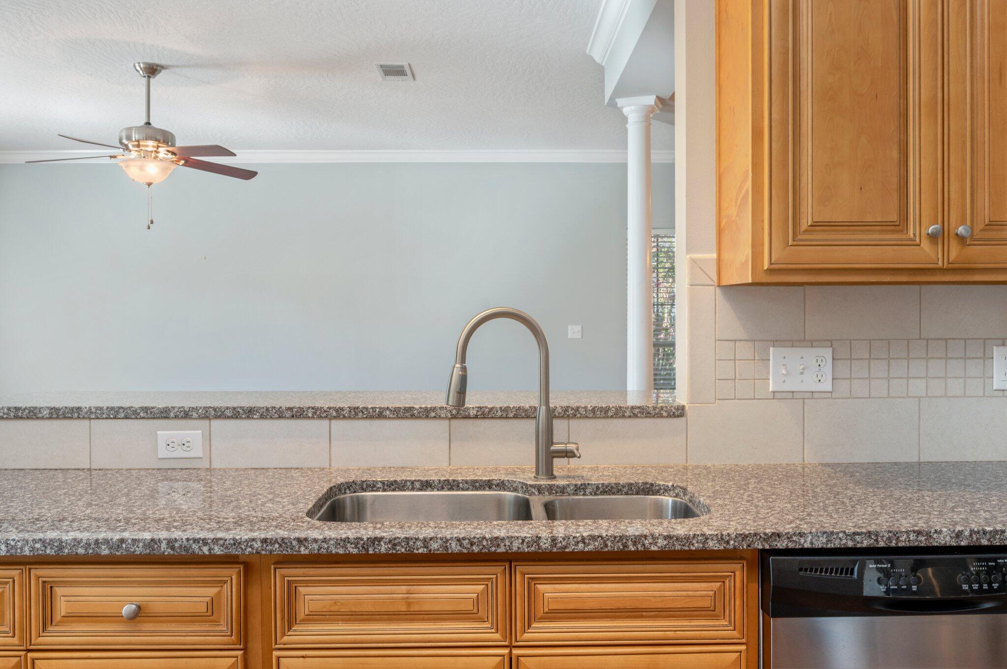 4623 Hermosa Road Crestview, FL 32539 - Photo 16 of 41 a kitchen with granite countertop a sink and cabinets