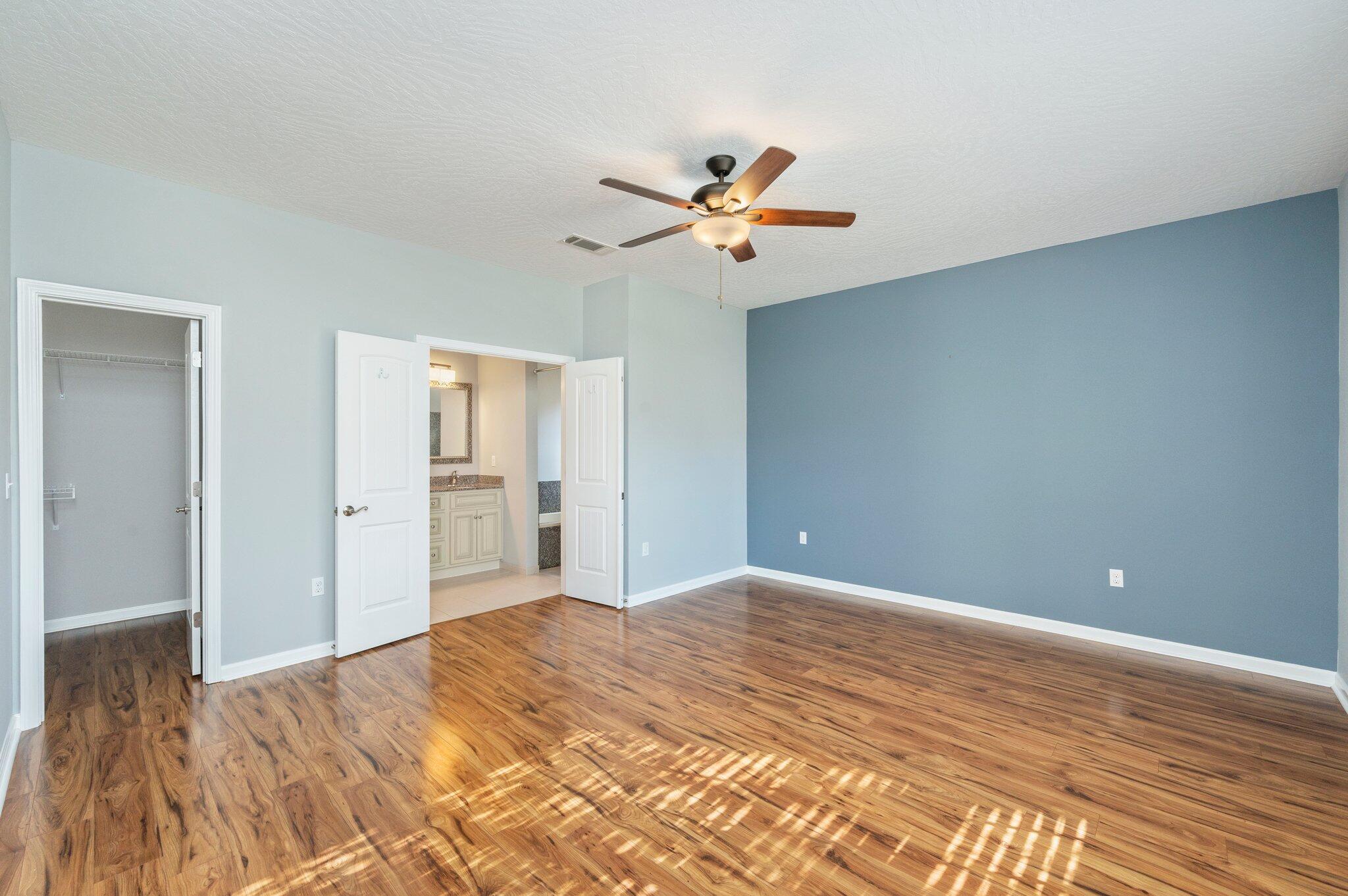 4623 Hermosa Road Crestview, FL 32539 - Photo 17 of 41 a view of a room with wooden floor and a ceiling fan