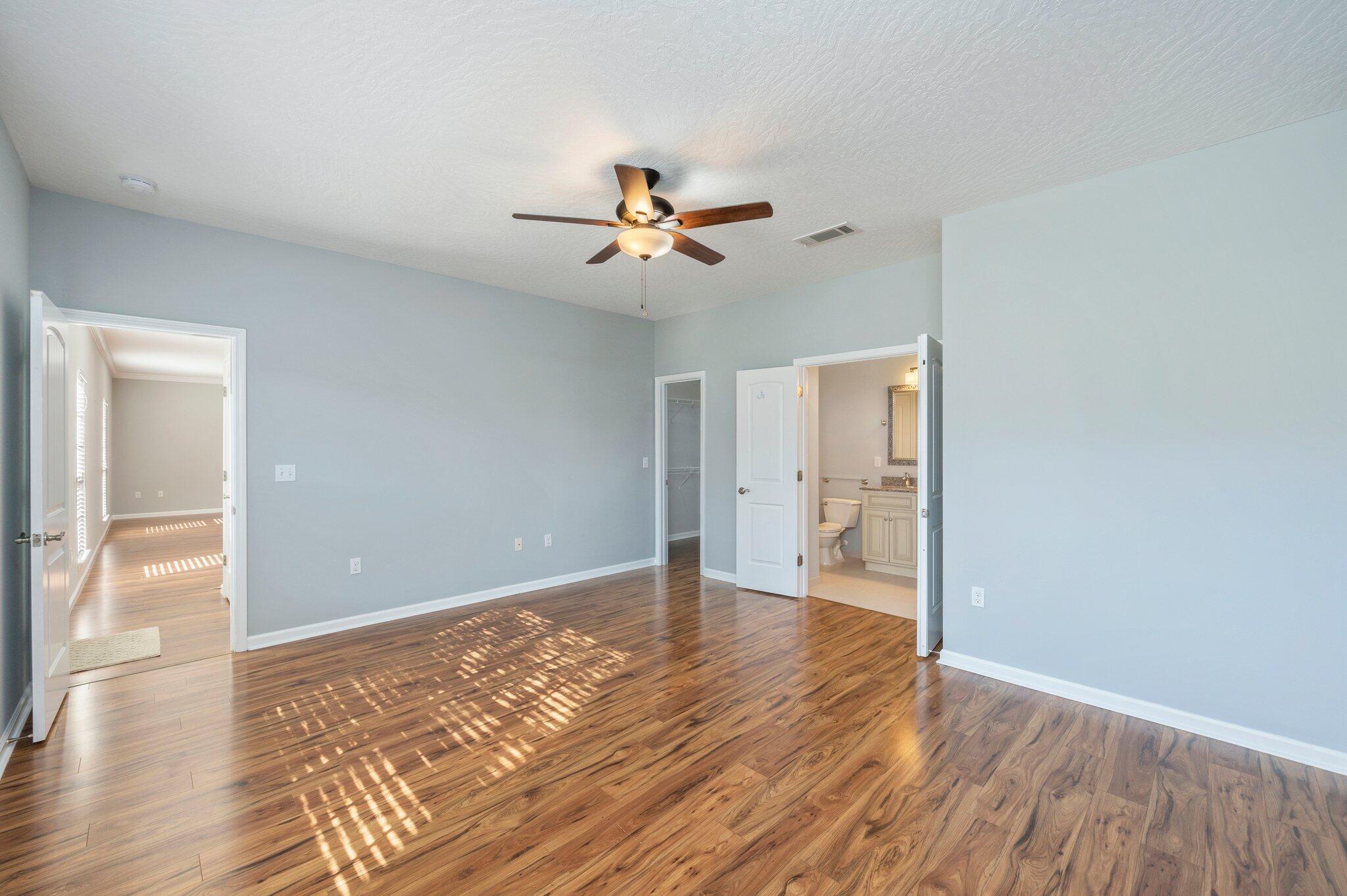 4623 Hermosa Road Crestview, FL 32539 - Photo 18 of 41 a view of empty room with wooden floor and fan
