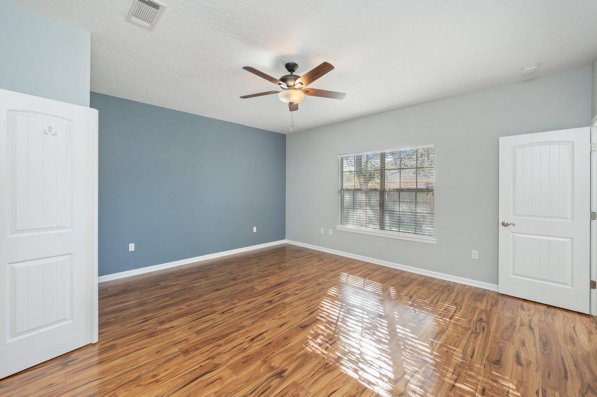 4623 Hermosa Road Crestview, FL 32539 - Photo 19 of 41 a view of an empty room with window and wooden floor