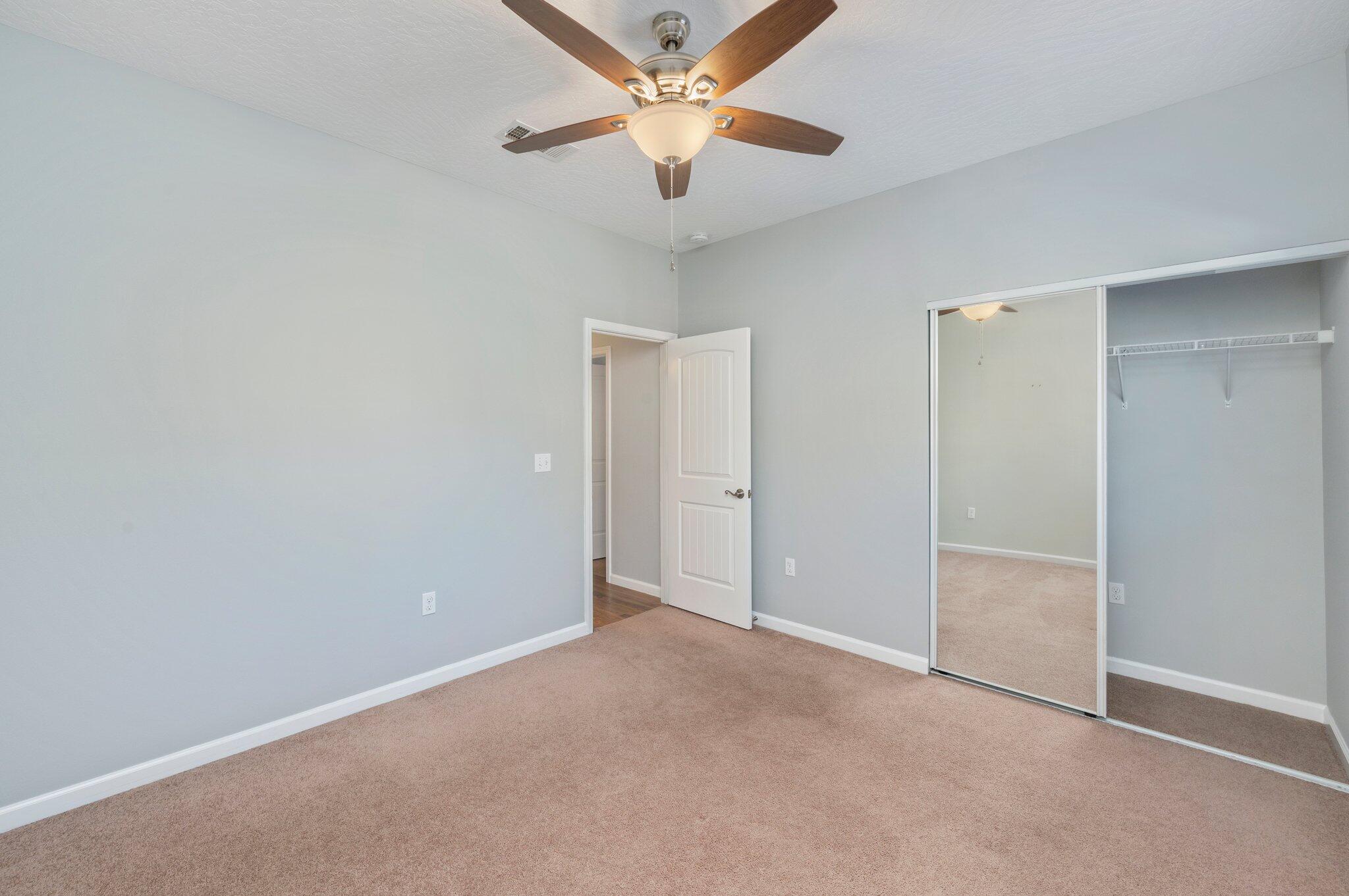 4623 Hermosa Road Crestview, FL 32539 - Photo 27 of 41 an empty room with closet and a ceiling fan
