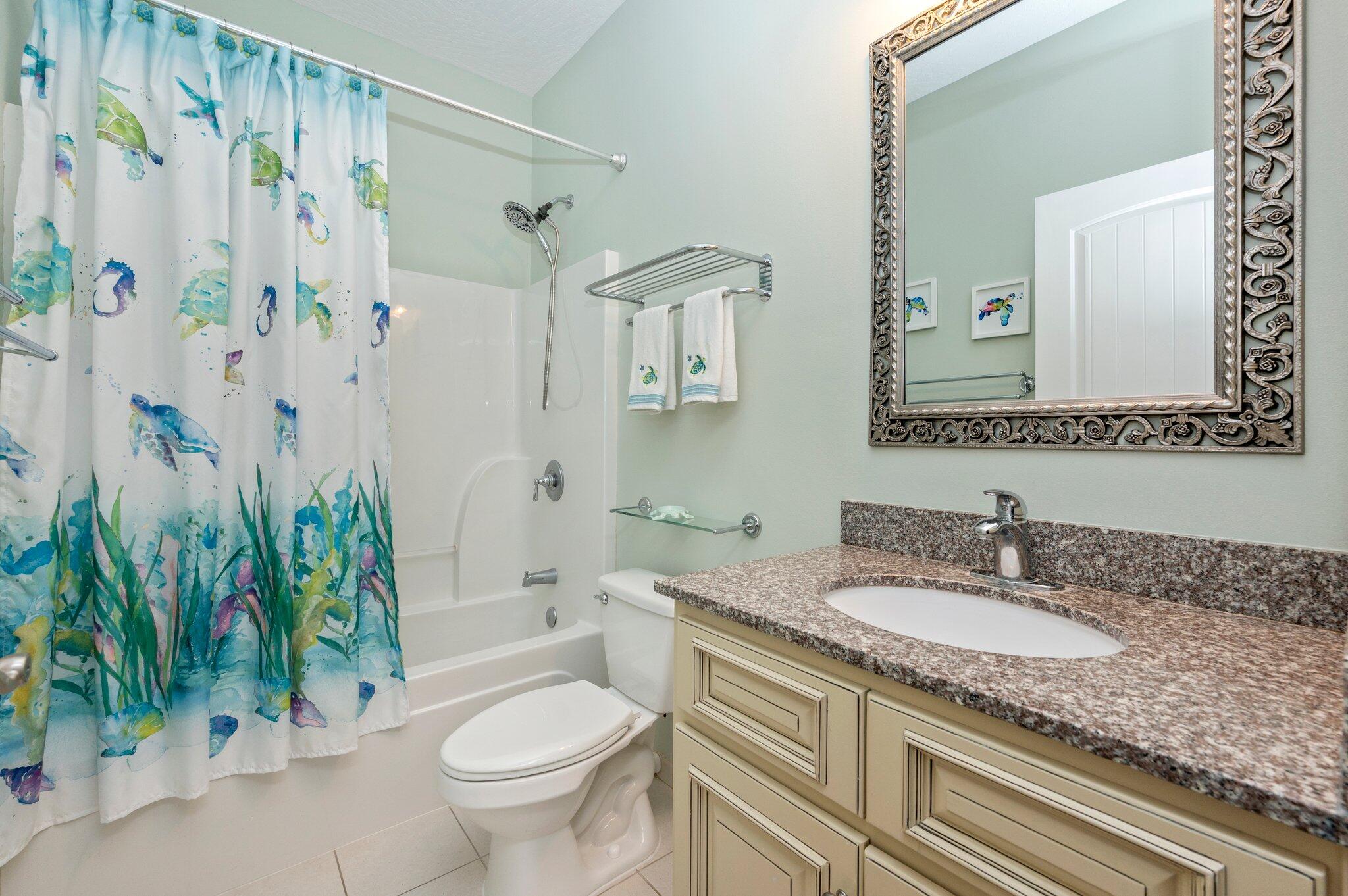 4623 Hermosa Road Crestview, FL 32539 - Photo 28 of 41 a bathroom with a granite countertop sink a toilet and a mirror