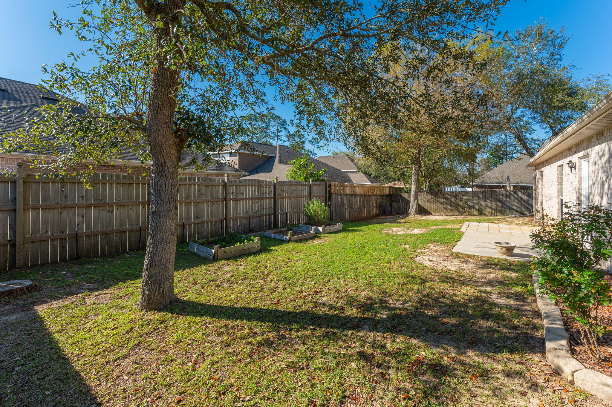 4623 Hermosa Road Crestview, FL 32539 - Photo 34 of 41 a view of a backyard with brick wall and plants