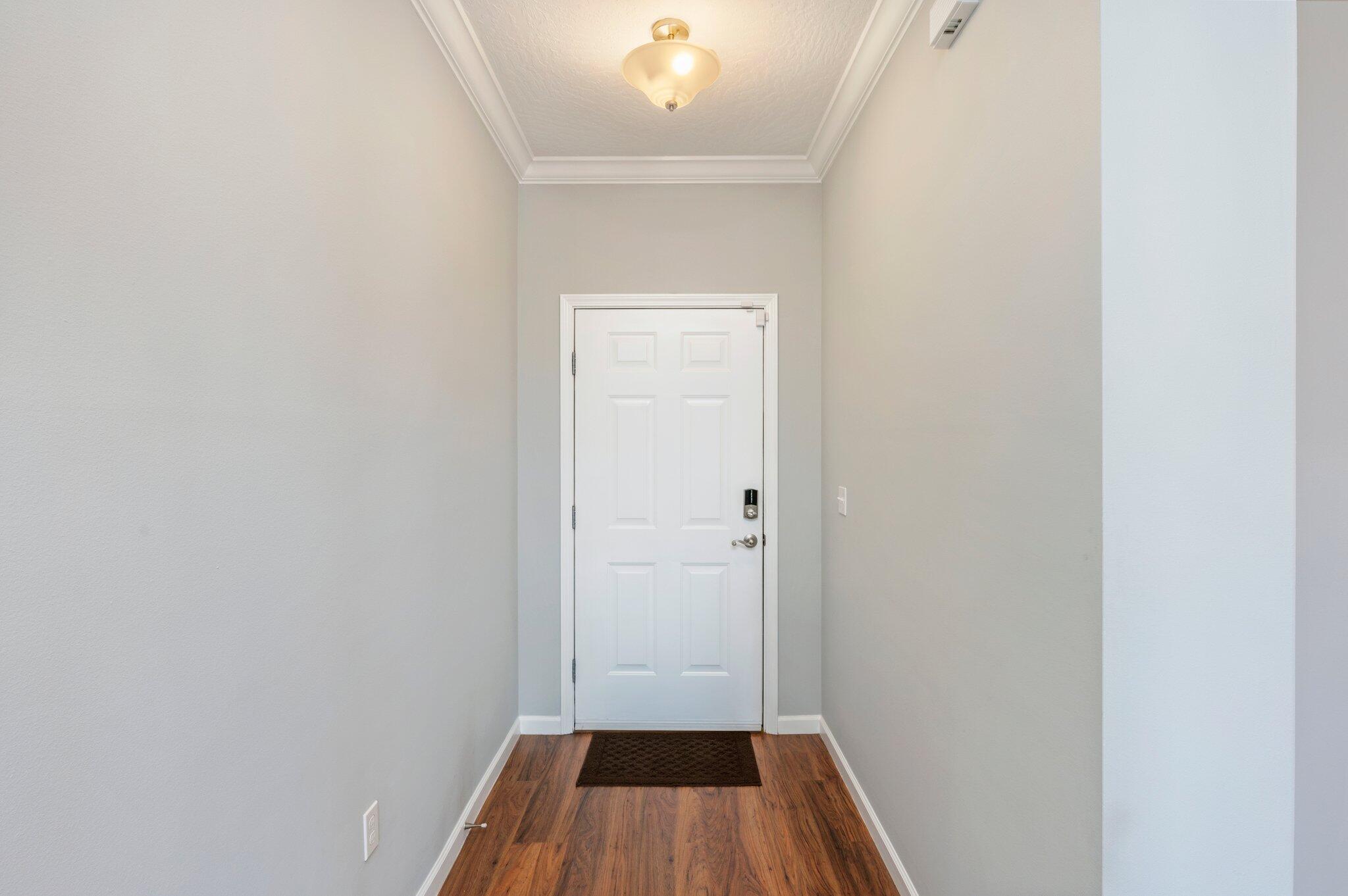 4623 Hermosa Road Crestview, FL 32539 - Photo 5 of 41 a view of a hallway with wooden floor