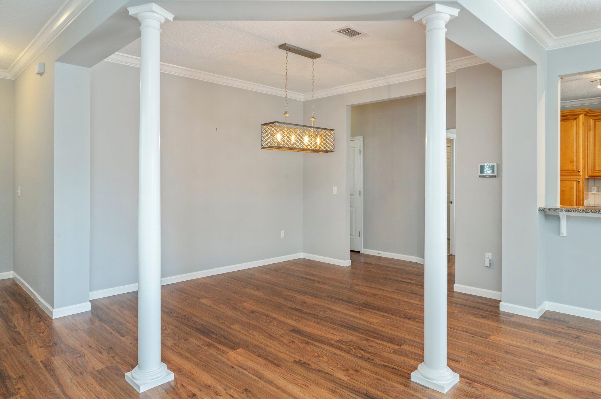 4623 Hermosa Road Crestview, FL 32539 - Photo 9 of 41 a view of a hallway with wooden floor and window