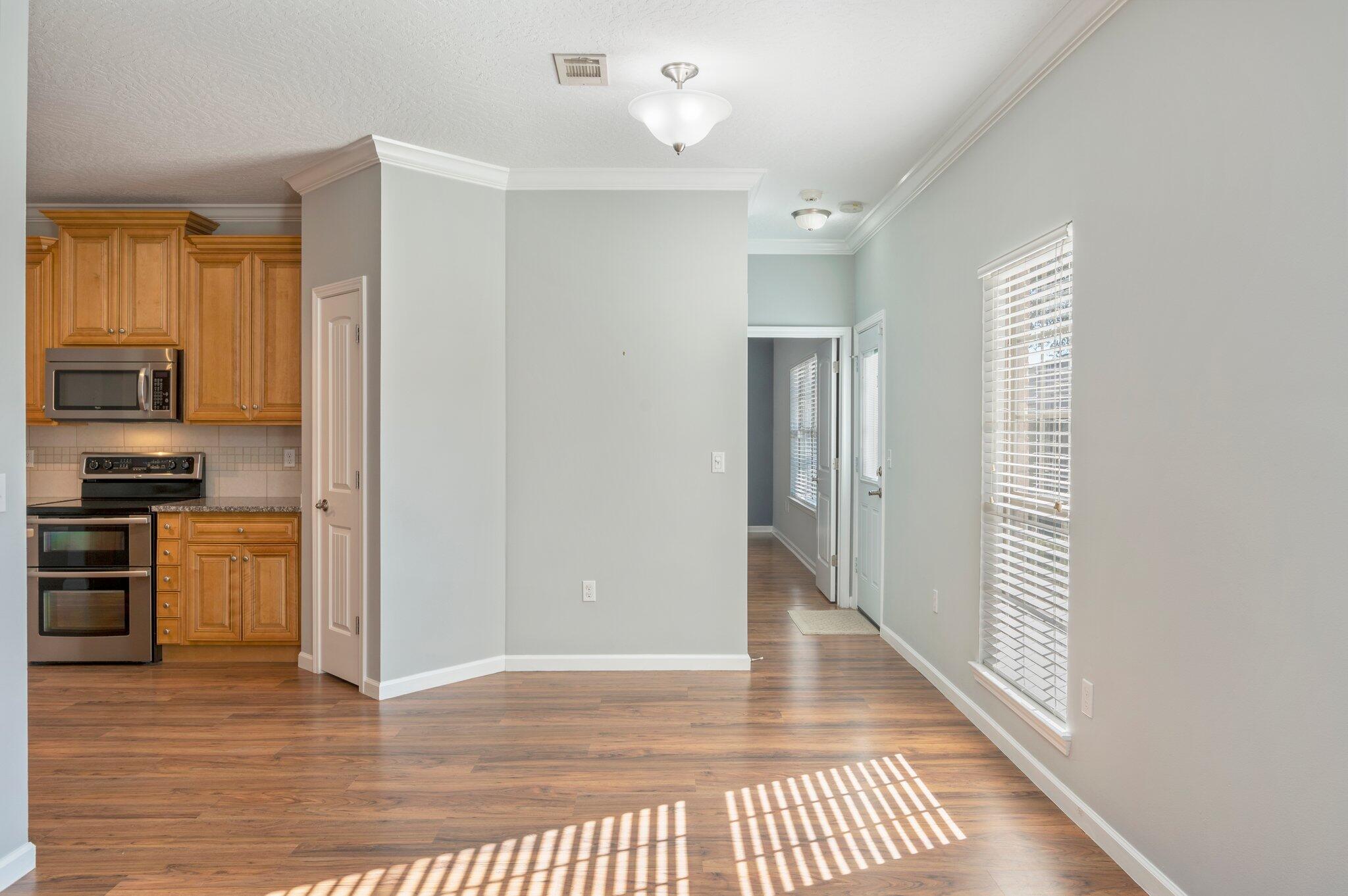 4623 Hermosa Road Crestview, FL 32539 - Photo 10 of 41 a view of a kitchen with wooden floor and a refrigerator