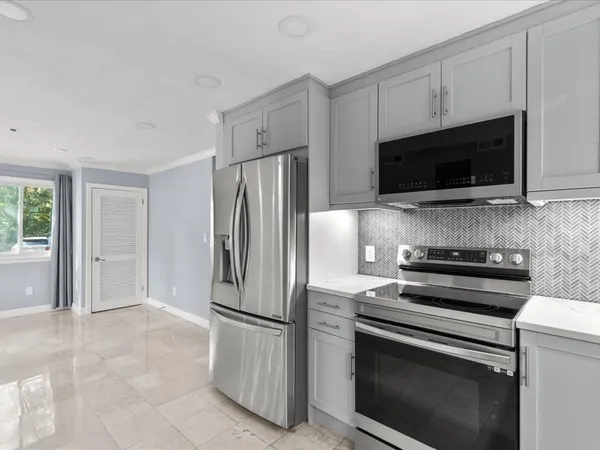 a kitchen with a refrigerator stove and microwave