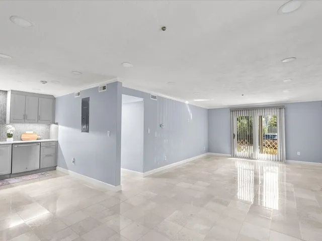 a view of a kitchen with a sink and a window