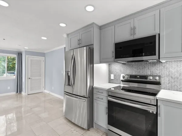 a kitchen with a refrigerator stove and microwave