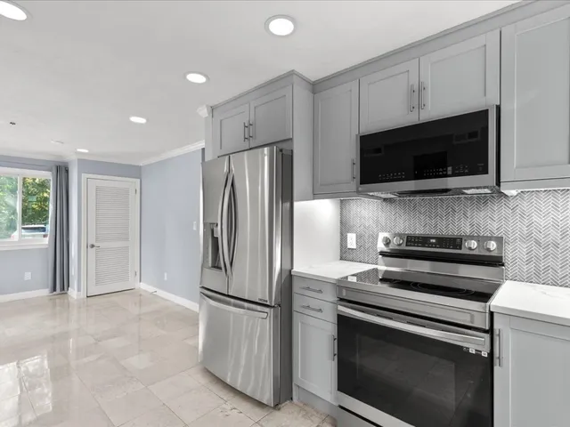 a kitchen with a refrigerator stove and microwave