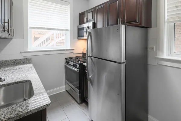 a kitchen with a refrigerator and a stove