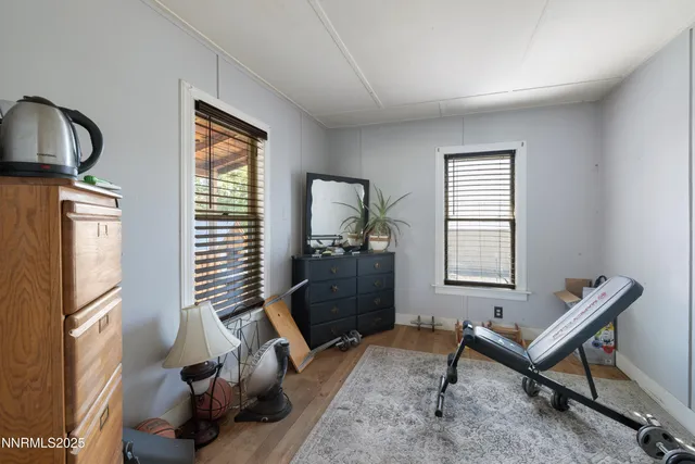 a living room with furniture a window and a flat screen tv