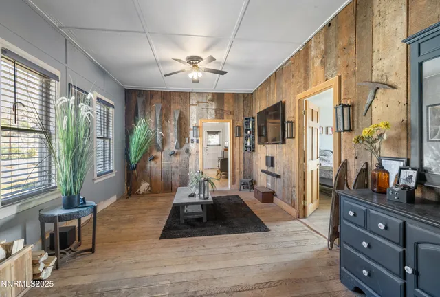 a living room with furniture windows and a chandelier
