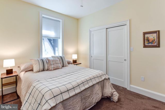 a bedroom with a bed and a mirror