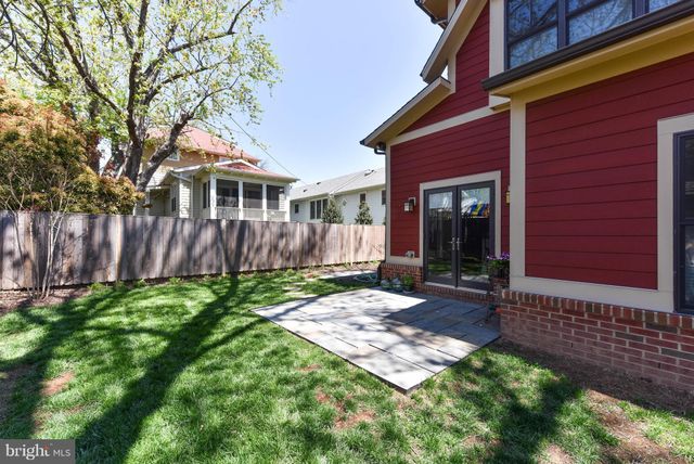 a view of a house with backyard and wooden fence