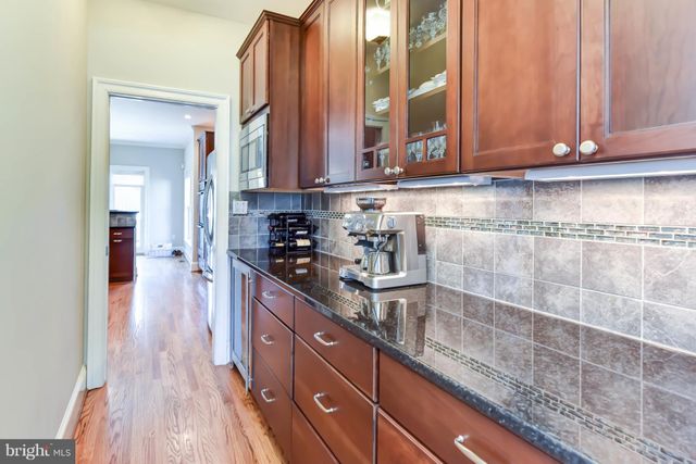 a kitchen with stainless steel appliances granite countertop a sink a stove and cabinets