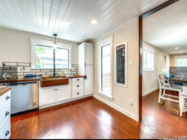 a large kitchen with granite countertop a large window and stainless steel appliances