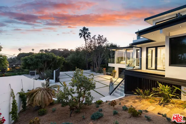 a view of a patio with table and chairs and potted plants